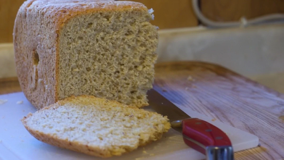 A freshly baked loaf of soft milk bread, cut to show its tender crumb